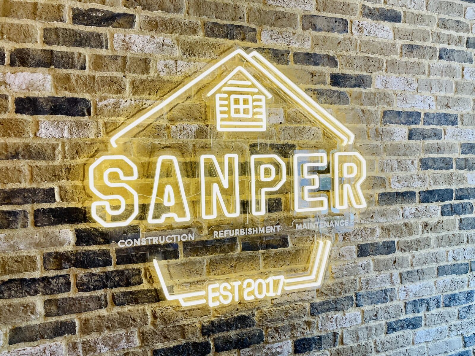 logo signage on brick wall
