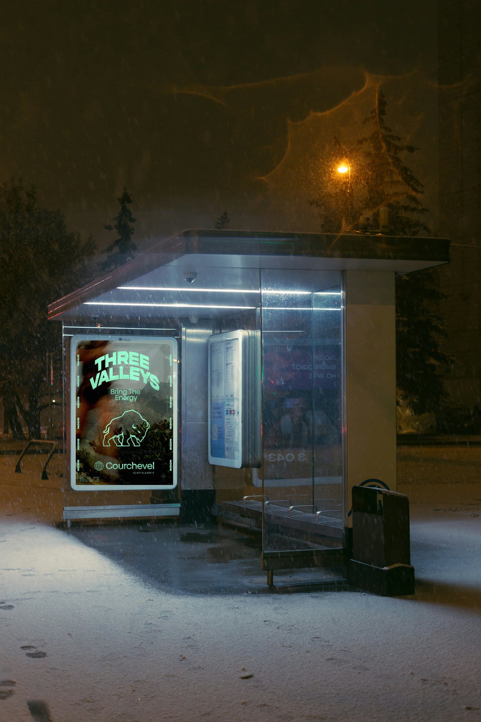 the Three Valleys poster in a bus shelter, in the snow at night