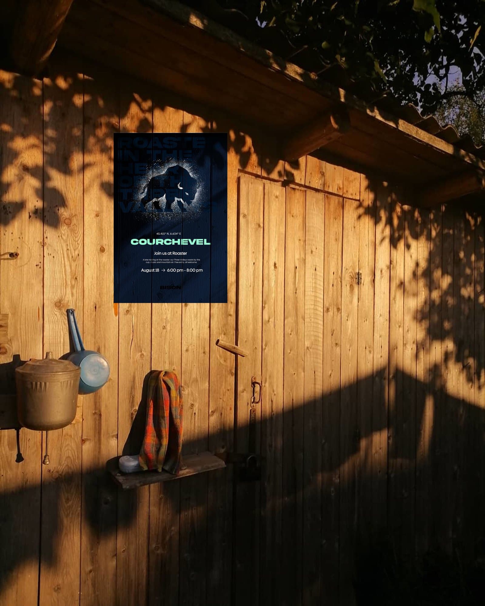 the Courchevel poster on a timber wall at sunset